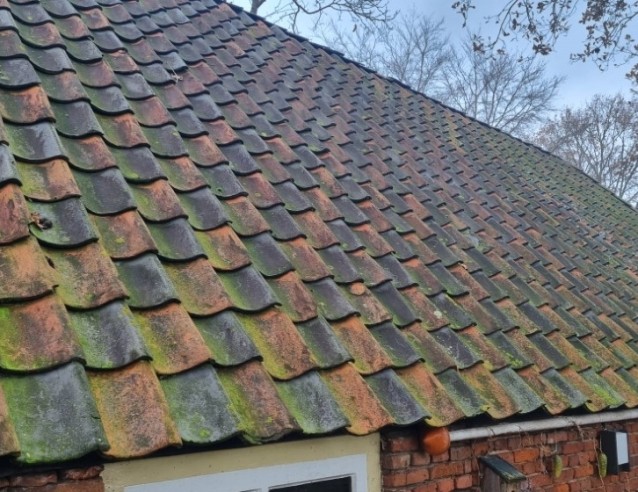 Foto van oude dakpannen met aanslag van mos en vervuiling. Na reiniging en behandeling met NanoEnzo nano coating worden ze weer waterafstotend, schoon en beschermd tegen verwering.